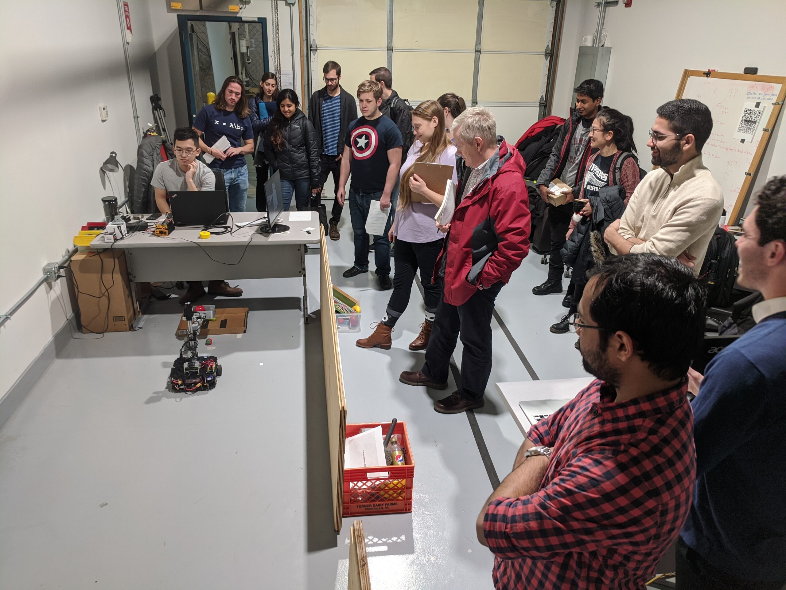 The instructors can place objects anywhere. CuBi runs autonomously, searching, finding, collecting obejcts and dumping them in the box until the whole area is clean.