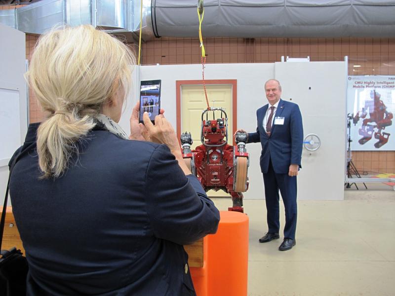 Serbian Ambassador poses with CHIMP at the National Robotics Engineering Center (NREC).